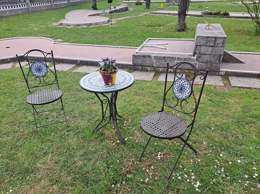 schöne Sitzgelegenheit mit 2 Stühlen und Tischchen auf Minigolfplatz